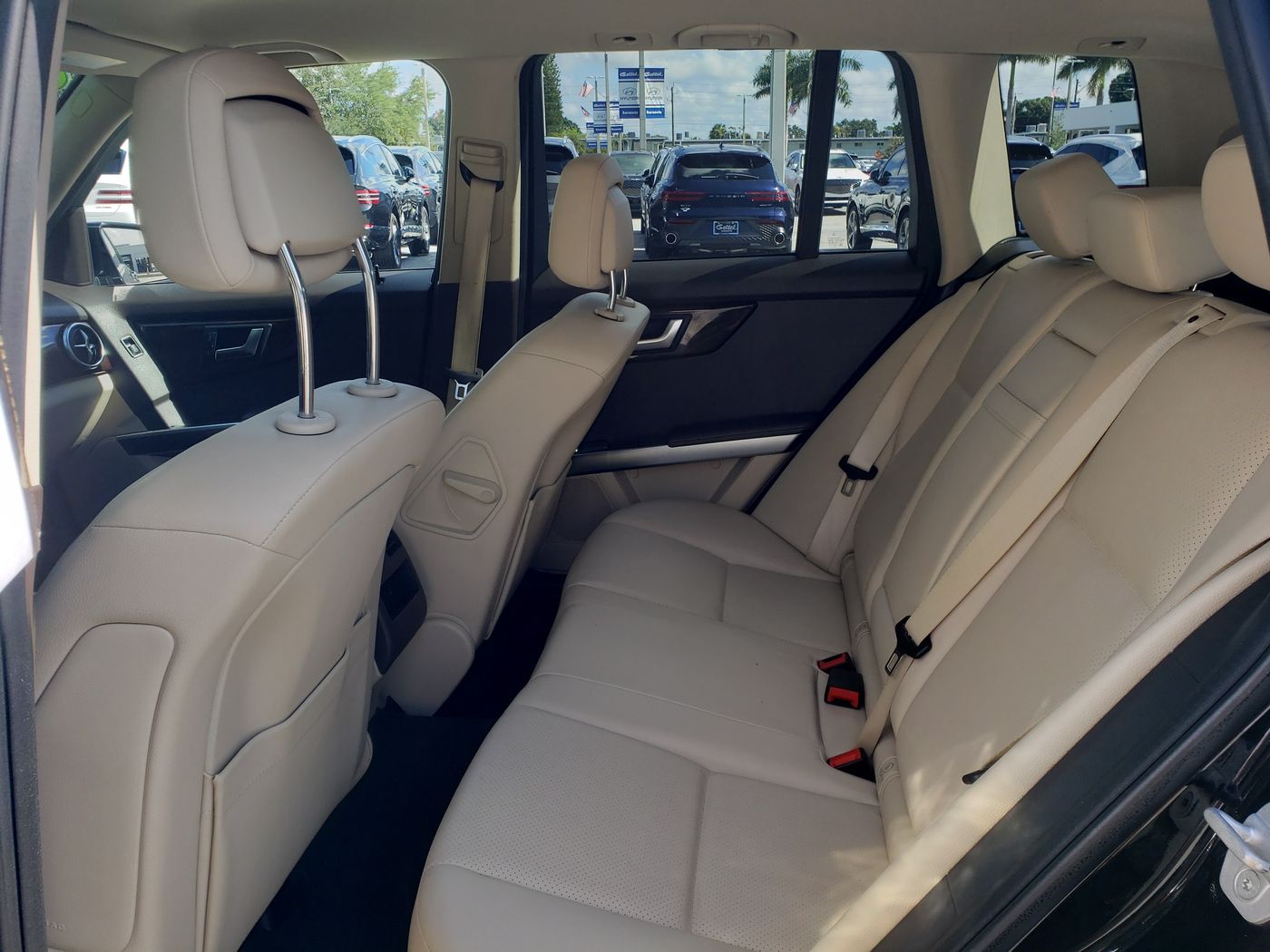 Beige leather rear interior photographed through an open door.