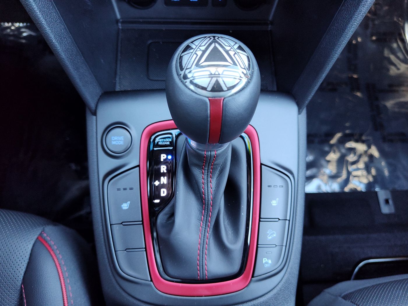 Close-up of a center console and gear shifter, HD interior still.